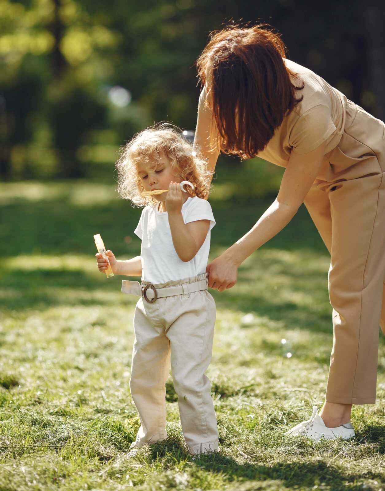 Elegant mother with daughter in a summer forest